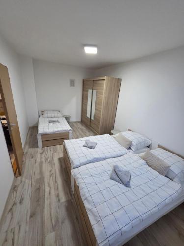 a room with two beds in a room at Apartmán KN in Liptovský Mikuláš
