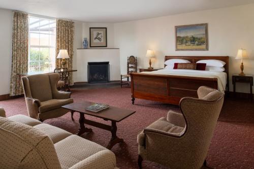 a hotel room with a bed and a fireplace at Arizona Inn in Tucson