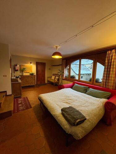 a bedroom with a large bed in a room at La Dimora della Fontana in Mozzio