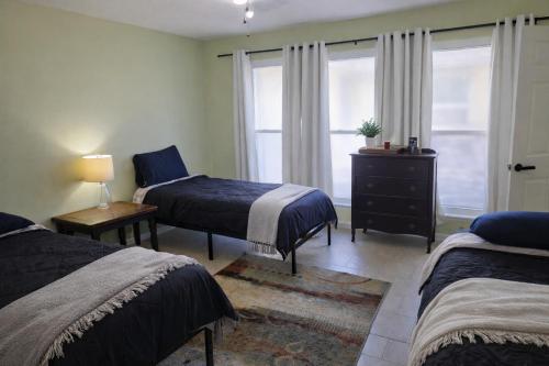 a bedroom with two beds and a window at Fresh Crash Pads 4-Affordable Shared Housing in Houston