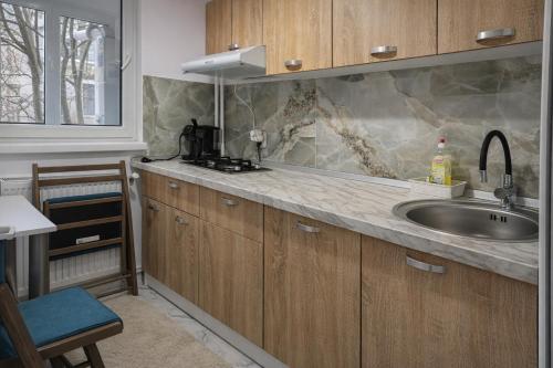 a kitchen with a sink and a counter at Justin Ultra-Central Apartment in Galaţi