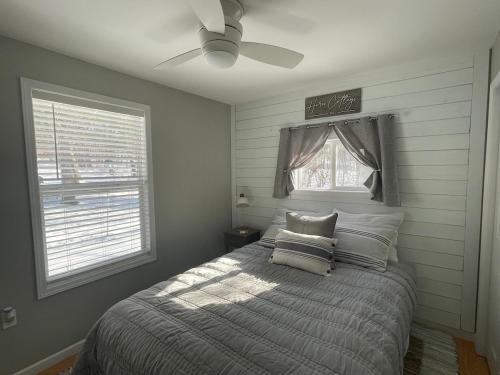 a bedroom with a bed and a ceiling fan at Heron Cottage on Cayuga Lake in Aurora