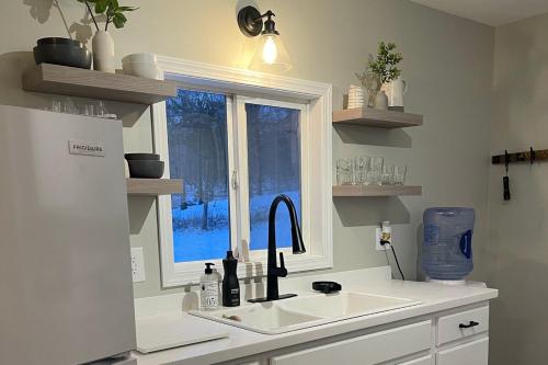 a kitchen with a sink and a window at Heron Cottage on Cayuga Lake in Aurora