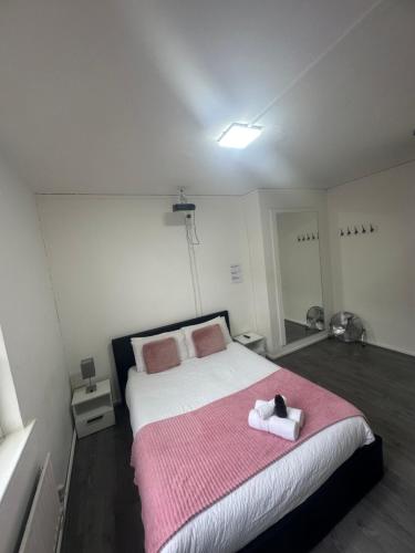a bedroom with a bed with a stuffed animal on it at Unique Double Bedroom in London