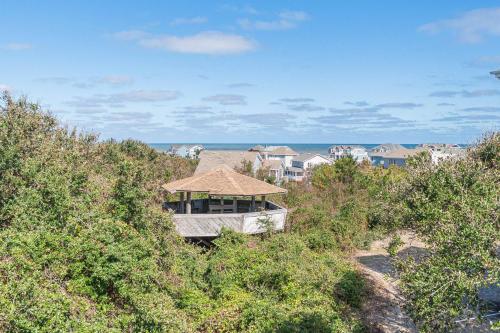 a house with a roof on top of a hill at Climate Change - Duck, Sea Tern, Oceanside, 280 Yds to Beach, Pool, Hot Tub, Pets OK in Duck