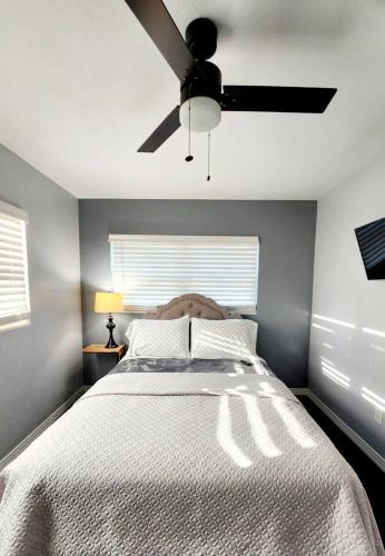 a bedroom with a bed with a ceiling fan at Blue Door House in Lakeland