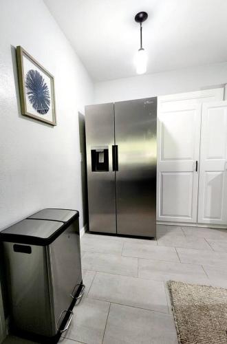 a kitchen with a stainless steel refrigerator in a room at Blue Door House in Lakeland