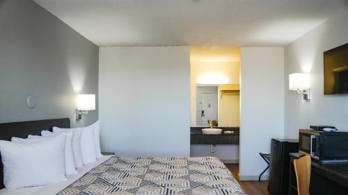 a hotel room with a bed and a microwave at Motel 6-Rolla, MO in Rolla