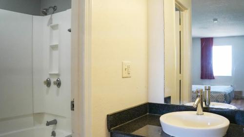 a bathroom with a sink and a mirror at Motel 6-Rolla, MO in Rolla