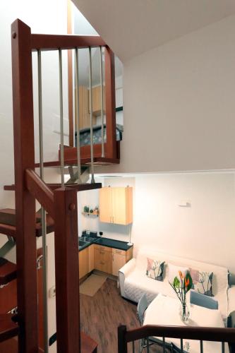 a living room with a couch and a staircase at Casa l'Apina Regina in Capriate San Gervasio
