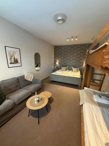 a living room with a couch and a bed at Målkullorna Hostel in Mora