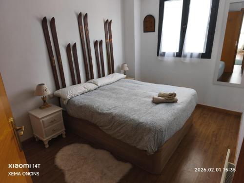 a teddy bear sitting on a bed in a bedroom at Apartamento Riglos Candanchu in Candanchú