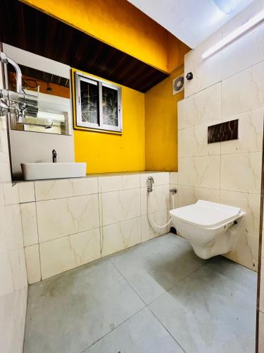 a bathroom with a toilet and a sink at Cutesy space in Kolkata