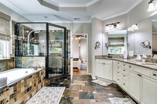 a bathroom with a shower and a tub and a sink at 6BD55B,BrookhavenSleeps 12,Big yard,w poolGate in Atlanta