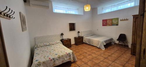 a bedroom with two beds and a desk and a window at Finca Don Sancho by Mayne in Lillo