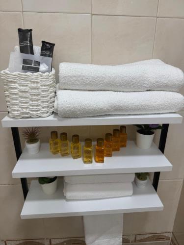 a white shelf with towels and towels at River Garden House in Vidin