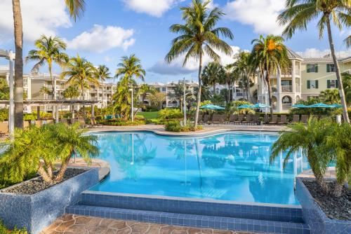 a swimming pool with palm trees and condos at Hyatt Vacation Club at Windward Pointe in Key West