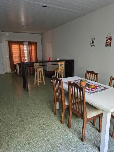 a dining room with a table and chairs and a ping pong table at Lisboa in Chacabuco