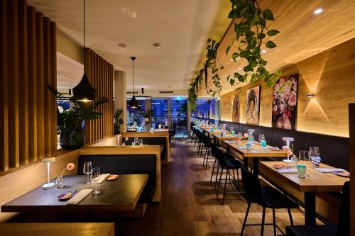 a restaurant with wooden tables and chairs in a room at Buchners Hotel & Restaurant in Niederwinkling