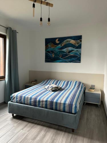 a bedroom with a bed and a painting on the wall at Casa Rosetta in Tignale