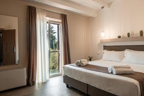 a bedroom with a large bed and a window at Manfredomus in Mussomeli