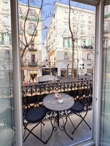 a table and chairs on a balcony with a view of a city at Suite Scarlatti in Naples