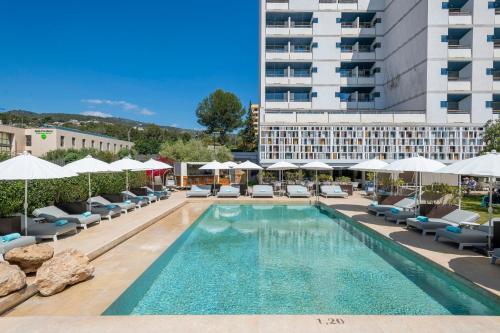 a swimming pool with lounge chairs and a hotel at Leonardo Boutique Hotel Mallorca Port Portals - Adults only in Portals Nous