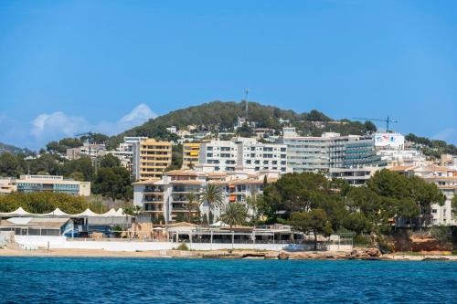 a group of buildings on a hill next to the water at Leonardo Boutique Hotel Mallorca Port Portals - Adults only in Portals Nous