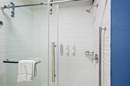 a shower with a glass door in a bathroom at Spark by Hilton Macon North in Macon