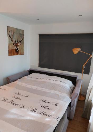 a bedroom with a bed with a deer on it at Chalet Klein Geluk in Lanaken