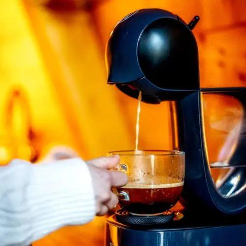 a person is making a cup of coffee at Bambusz-Kabin in Bárdudvarnok