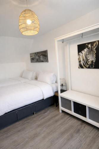 a bedroom with two beds and a mirror at Modern Spacious Flat In Ipswich - Sleeps 6 - Parking in Freston