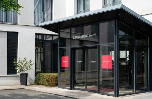 a glass entrance to a building at Leonardo Hotel Dresden Altstadt in Dresden