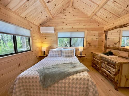 a bedroom with a bed in a wooden cabin at Cozy Coastal Cabin 2 in Steuben