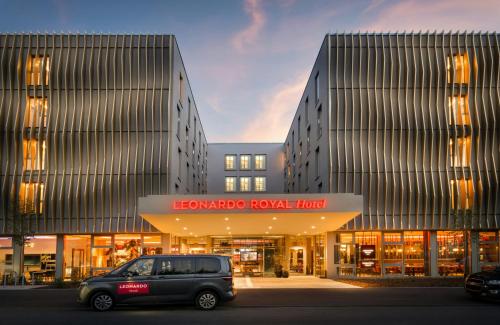 a van parked in front of a building at Leonardo Royal Hotel Cologne Bonn Airport in Cologne