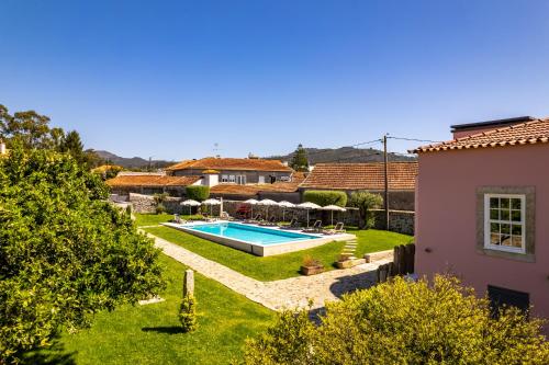 a garden with a swimming pool and a house at Casa Da Brêa Viana do Castelo - Villa & Apartment in Viana do Castelo