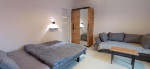 a living room with a bed and a couch at na Słowackiego9m7 in Szklarska Poręba