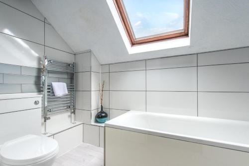 a bathroom with a toilet and a sink and a window at 2 Bed in Swimbridge oc-n0208 in Swimbridge