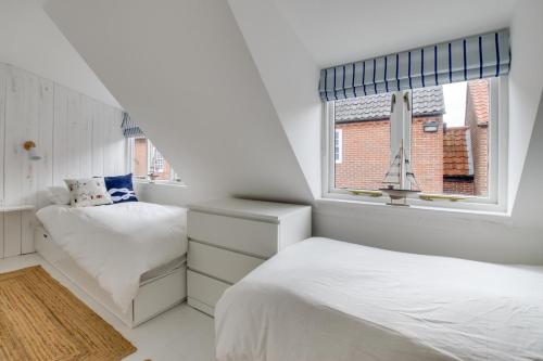 two beds in a white room with a window at 2 Bed in Southwold oc-19cs in Southwold