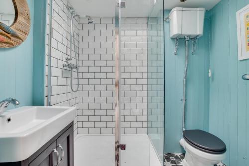 a bathroom with a toilet and a sink and a shower at 2 Bed in Southwold oc-19cs in Southwold