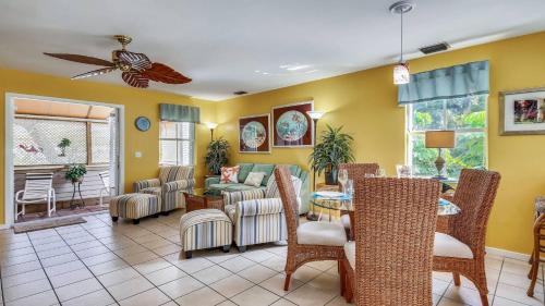 a living room with yellow walls and a table and chairs at Duval Sea Turtle by AvantStay Great Location Close to Shops Shared Pool in Key West