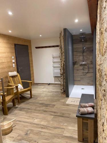a bathroom with a shower with a bench and a table at Chez Netty Gite avec sauna à Beblenheim in Beblenheim