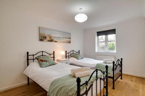 two beds in a bedroom with white walls at 2 Bed in Broadstairs oc-th013 in Broadstairs