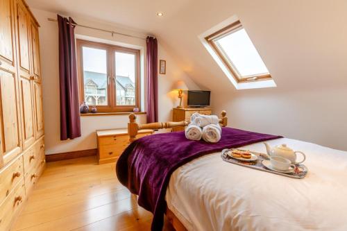 a bedroom with a bed with a tray of food on it at 3 Bed in Marazion oc-m30668 in Marazion