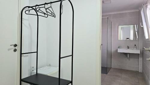 a glass shower in a bathroom with a sink at GOLDEN TOWER pensión Auto Check-in in Gandía