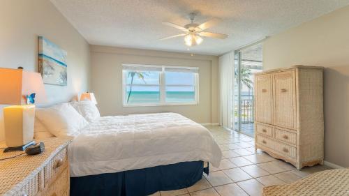 a bedroom with a bed and a window with the ocean at Brisa Del Mar by AvantStay Communal Pool Gated Community Ocean Front in Key West