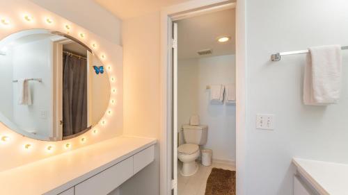 a bathroom with a mirror and a toilet at Brisa Del Mar by AvantStay Communal Pool Gated Community Ocean Front in Key West