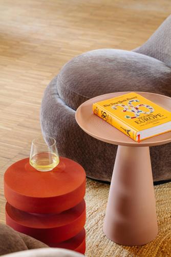 a table with a book and a glass of wine at Leonardo Hotel Groningen City Center in Groningen