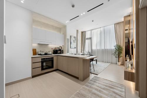 a kitchen with a sink and a counter top at Private Pool - Amazing 1BR Apartment in JVC in Dubai