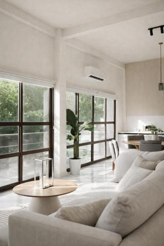 a living room with a white couch and a table at Nomad Luxe Tulum in Tulum